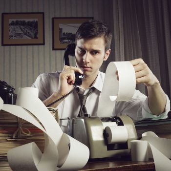 An male accountant at telephone  preparing income taxes